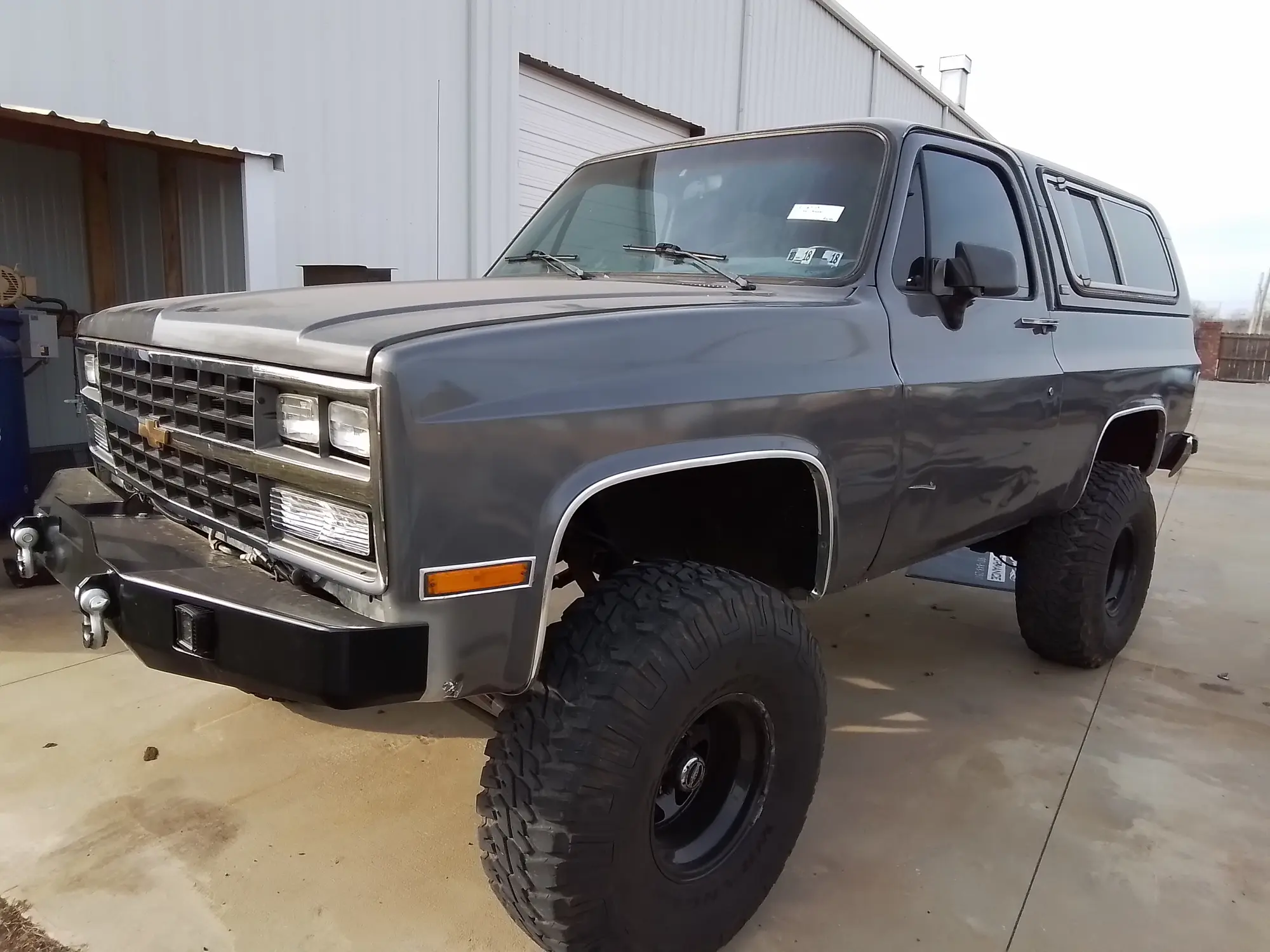 Gray Chevrolet Blazer photographed from the front three-quarter angle outside the shop